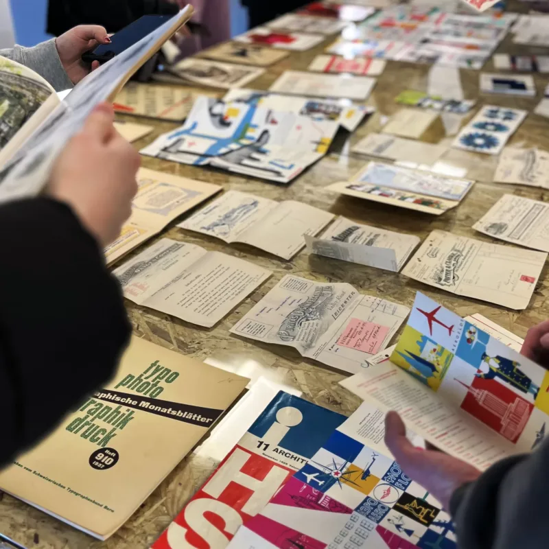 Students exploring various printed materials.